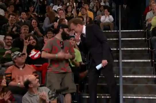 the grey shirt gentleman's robot arm offers you a sausage, Conan.